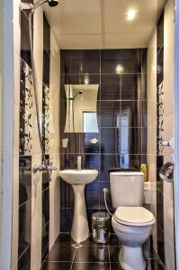 a bathroom with a toilet and a sink at Bubolina House in Sapareva Banya