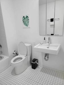 a white bathroom with a toilet and a sink at 629 Lofts 810 - A KCM Property in Cleveland