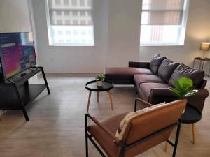 a living room with a couch and a tv at 629 Lofts 810 - A KCM Property in Cleveland