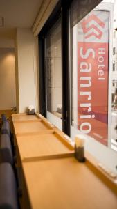 a row of tables in a room with a sign at Hotel Sanrriott Osaka Hommachi in Osaka