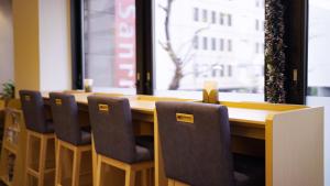 a conference room with a table with chairs and a window at Hotel Sanrriott Osaka Hommachi in Osaka