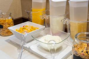a counter topped with bowls of different types of food at Hotel Sanrriott Osaka Hommachi in Osaka