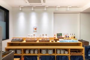 a room with wooden shelves with food on them at Hotel Sanrriott Osaka Hommachi in Osaka