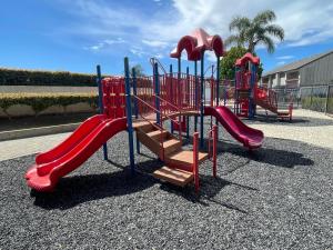 a playground with a red slide at MAGICAL Xcape, POOLS-SPA, WALK 2 DISNEY, CENTRAL AC-HEAT, FULLY EQUIPPED, 2 FREE PARKING SPACES, OWNER MGMT in Anaheim