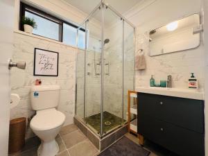 a bathroom with a shower and a toilet and a sink at Penrith Beautiful Granny sleep 4 in Penrith