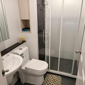 a small bathroom with a toilet and a shower at Sukhumvit​ 101 in Phra Khanong