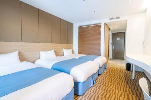 Postel nebo postele na pokoji v ubytování Hotel Whistlelark Jeju