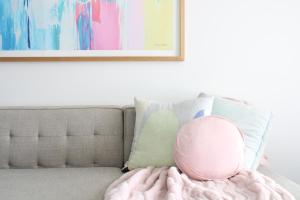 a pink ball sitting on a couch with pillows at Bottlebrush Moama in Moama