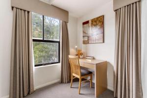 a room with a desk with a chair and a window at 2BDR 1BTH - James Street Magic in Perth