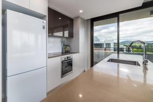 a kitchen with white appliances and a large window at Spacious 2-Bed, Stunning Views in Central Canberra in Kingston 