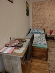a small room with a table and a bed at Mária in Košice