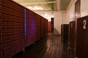 a row of lockers in an office building with a hallway at Garpeza Backpackers in San Vicente