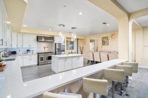 a large kitchen with white cabinets and a large island at Luxurious Estate w/ Heated Pool and Amazing Views in San Bernardino