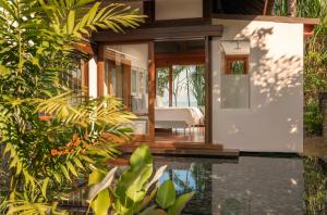 a house with a pool in front of it at Four Seasons Resort Langkawi in Tanjung Rhu