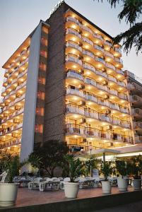 a large building with tables in front of it at Hotel Yantra in Sunny Beach