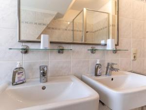 a bathroom with two sinks and a mirror at Luxury holiday apartment in St Peter Ording in St. Peter-Ording