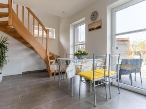a dining room with a glass table and chairs at Ferienwohnung in St Peter Ording in Sankt Peter-Ording