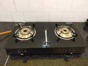 a stove top with two pots on top of it at Behala home stay in Kolkata