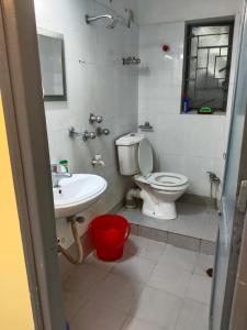 a bathroom with a toilet and a sink at Behala home stay in Kolkata