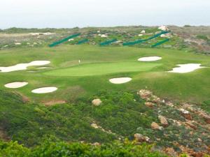 a group of golf courses on a hill with water at Pinnacle Lodge 1089 in Dana Bay
