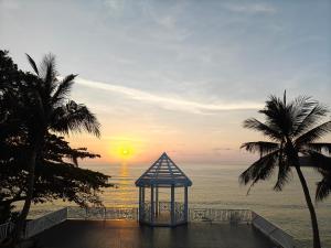 a gazebo on the beach with a sunset at Bhundhari Resort & Villas Samui in Chaweng