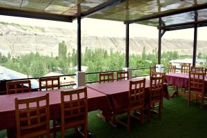 a dining room with a table and chairs with a view at Hotel Rangyul in Kargil