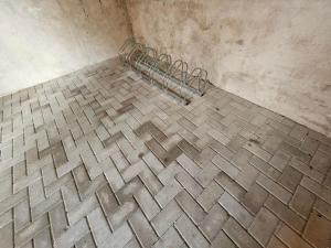 a tiled floor with a metal rack in a room at Gästewohnung Heinrich Heine Schule in Bad Dürrenberg