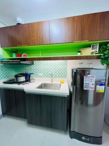 a kitchen with a stainless steel refrigerator and a sink at Studio 7 in Manila