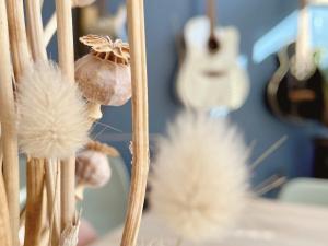 a bunch of dried dandelions and a guitar at La Jabotte in Antibes