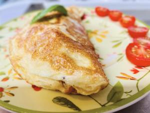 a plate with a piece of puff pastry and tomatoes at La Jabotte in Antibes