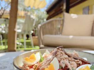 a plate of food on a table with an egg andopus at La Jabotte in Antibes