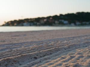 a sandy beach with footprints in the sand at La Jabotte in Antibes