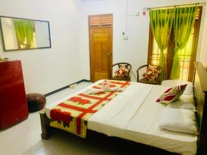 a bedroom with a bed in a room at Shehan Villa in Beruwala