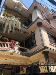 a building with a balcony with flowers on it at Diamond Home Stay - Private Rooms in Kathmandu