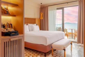 a hotel room with a bed and a balcony at Novva Hotels Kas in Kas