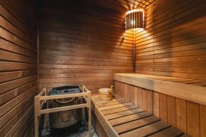 an empty wooden sauna with a stove in it at Hotel Jizerka 4 in Jizerka