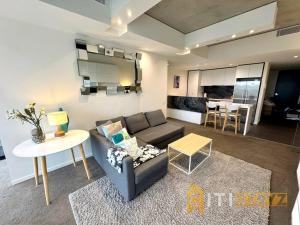 a living room with a couch and a table at Nice in New Acton - 2bd 2bth Apt in Canberra