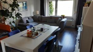 a living room with a table and a couch at Gästezimmer im Freudenthal in Extertal