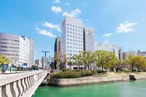 a bridge over a river in a city with buildings at Hiroshima Intelligent Hotel Annex in Hiroshima