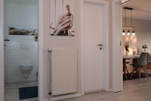 a bathroom with a radiator next to a table at FEWO Ostseeland in Grömitz