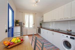 a kitchen with a table with a bowl of fruit on it at Τhalassa Home Fine Living in Petra