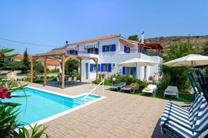 a villa with a swimming pool and a house at Τhalassa Home Fine Living in Petra +7 photos