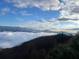 a view of a mountain with clouds in the valley at Karadzhovata Kashta in Zlatograd