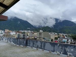a view of a city with a mountain in the background at Hotel Royal Stay , Katra in Katra