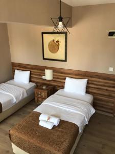 a hotel room with two beds and towels on a bench at PARK OTEL in Duzce