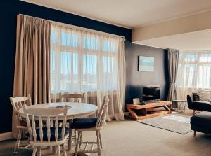 a living room with a table and chairs and a couch at Hokitika Beach Break in Hokitika