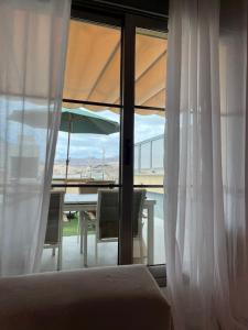 a bedroom with a bed and a table and a window at Luxury House - Puerto Rico in Puerto Rico de Gran Canaria +21 photos