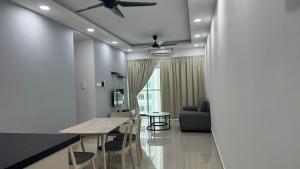 a kitchen and living room with a table and a couch at HH KL Prime location Residence near TRX in Kuala Lumpur