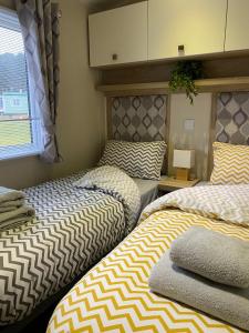 two beds sitting next to each other in a room at No. 40 Golf View in Jedburgh