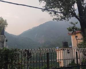 a fence with a mountain in the background at Hotel Royal Stay , Katra in Katra